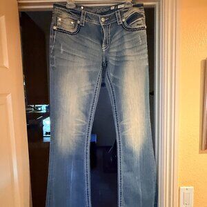 Super fashionable jeans with extensive bold stitching and stud-work. Size: 31